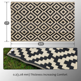 SAND MINE reversible outdoor rug placed on the beach for color versatility