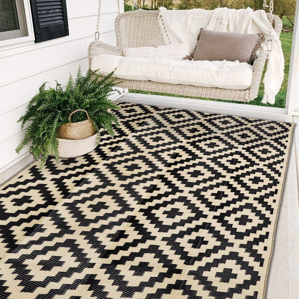 SAND MINE waterproof outdoor rug in black and beige on a patio for durable outdoor decor