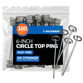 Sandbaggy 6-inch circle-top pins securing landscape fabric with wind resistance.