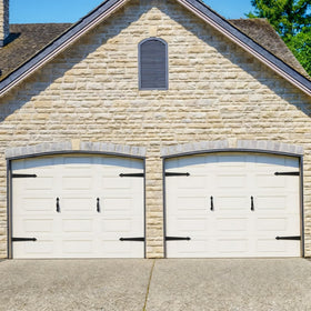 SANKEYTEW decorative handles on a black garage door offer stylish detail.