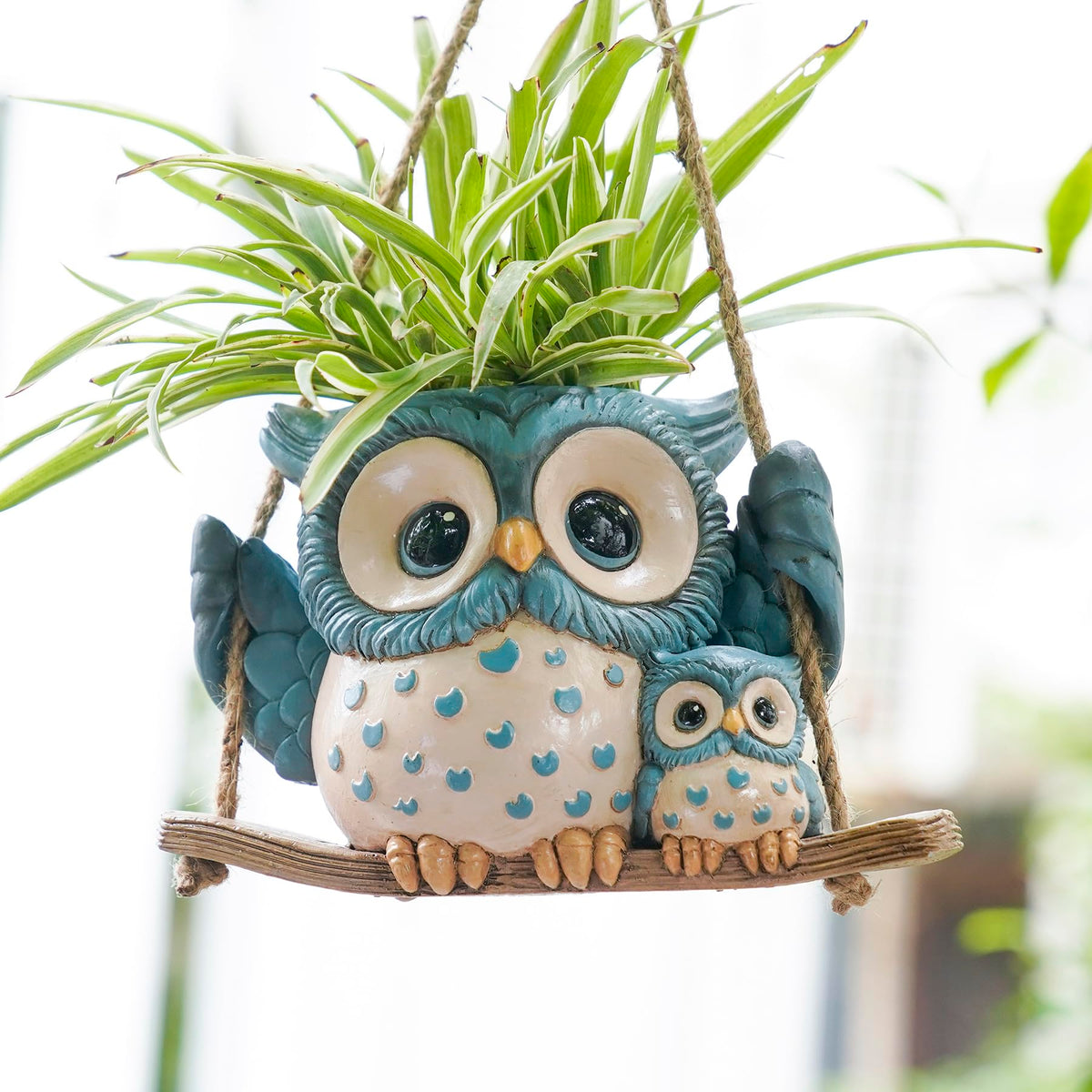 Saysmile Swing Owl Planter hanging indoors with a playful owl duo and blooming greenery.