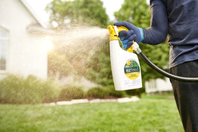 Scotts EZ Feed Plus Weed Control bottle ready for hose spray across the lawn.