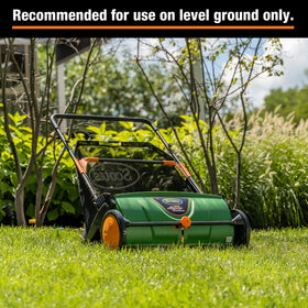 Scotts LSW70026S performing dry leaf pickup on a flat lawn with spinning brushes.