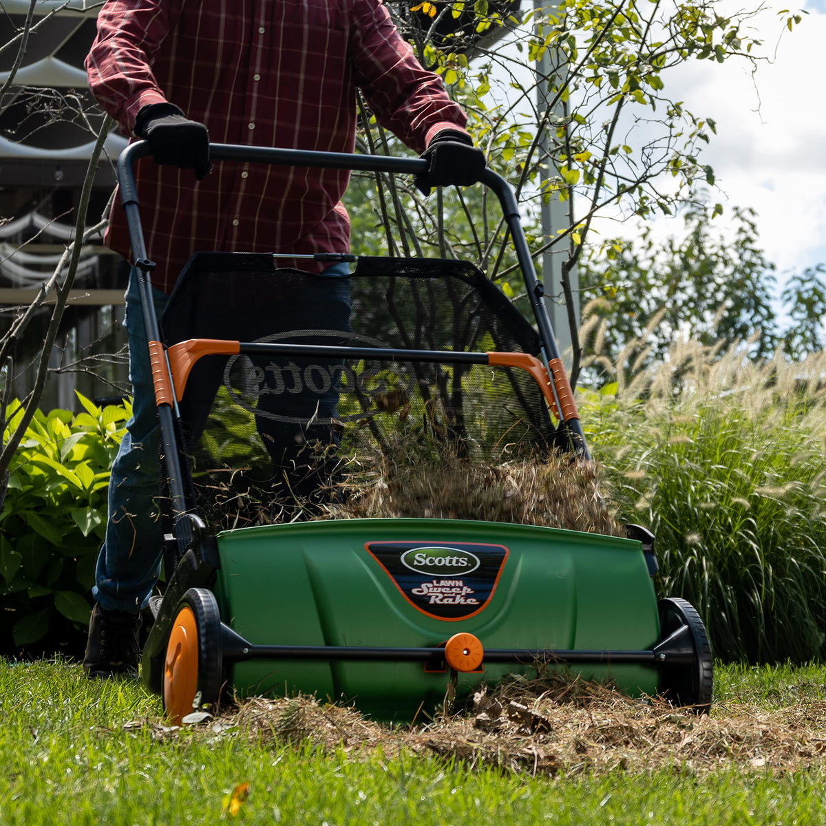 Scotts LSW70026S sweeper side view showing adjustable handle height for easy maneuvering.