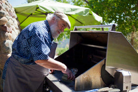 Easy-grip SCRUBIT tool in action on grill grates.