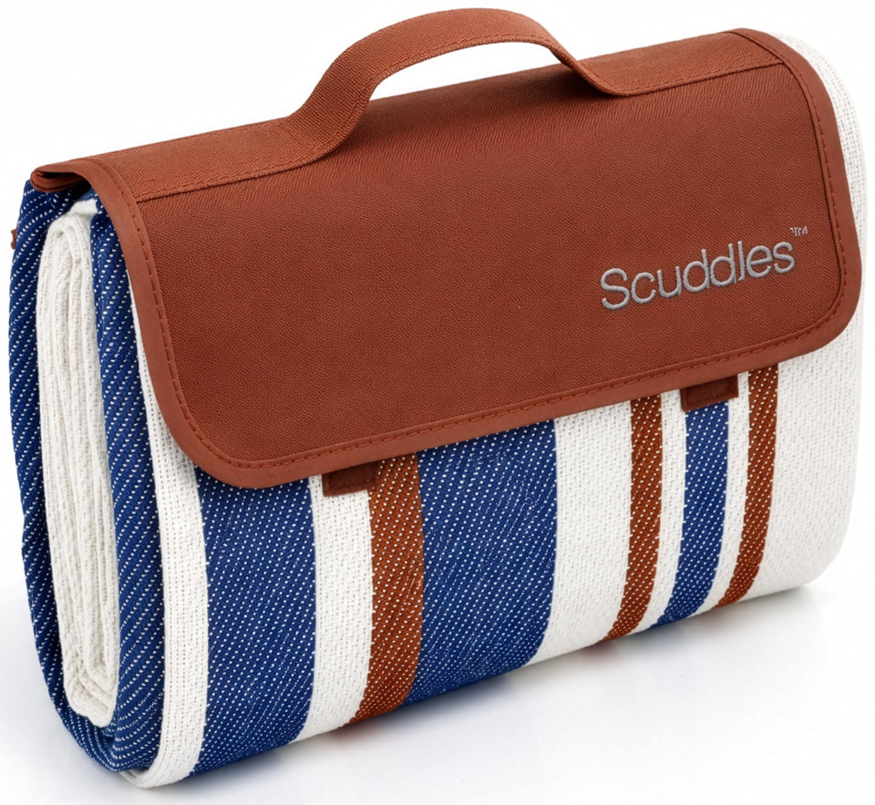 scuddles extra-large picnic blanket folded with carry strap for easy transport and storage.
