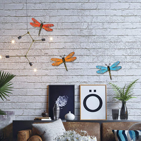 Scwhousi 3-pack dragonfly wall decor shown on a fence or gate.