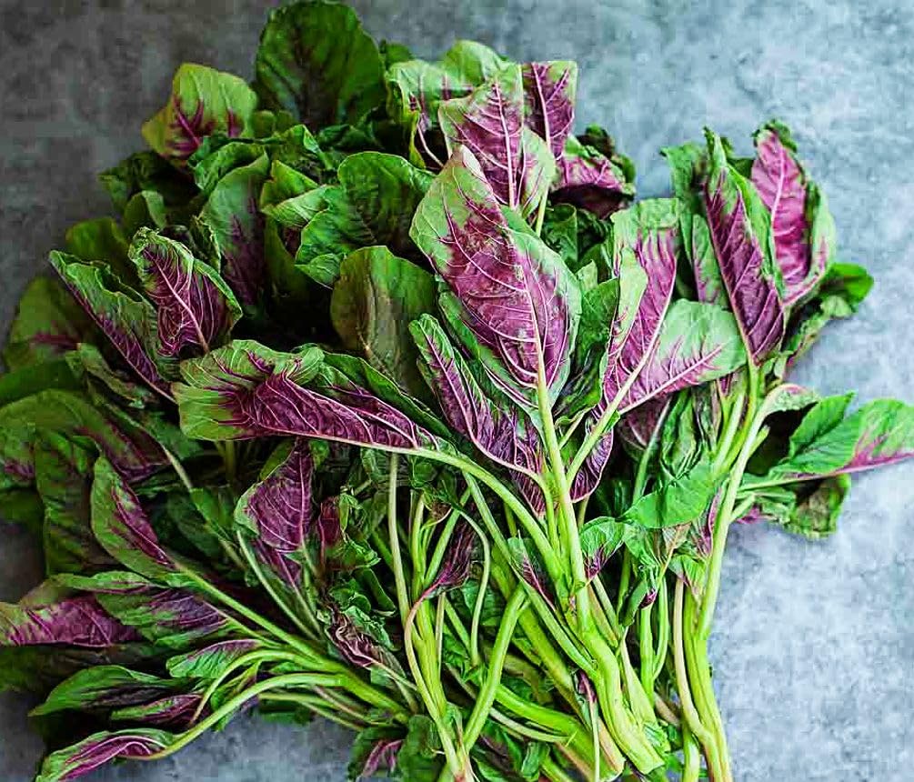 Seeds Of Strength cooking amaranth leaves in salads and stir-fries.