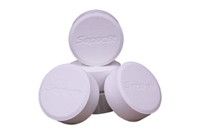 Close-up of Septicfit calcium hypochlorite tablet for system sanitation.