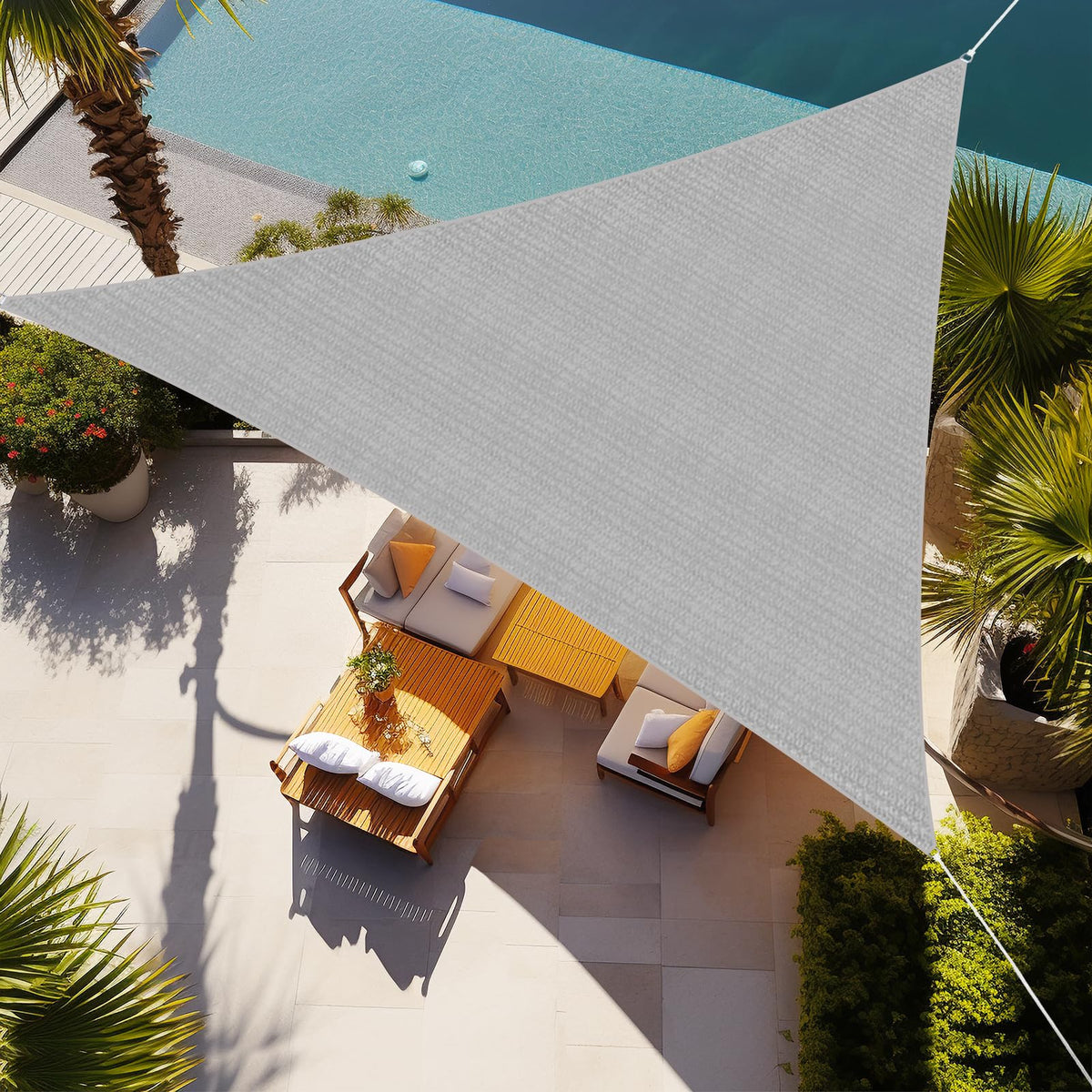 Shade&Beyond triangle sun shade sail 16x16x16 over a patio providing stylish shade.