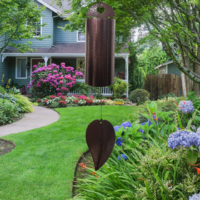 Sharita copper serenity bell wind chime in garden setting