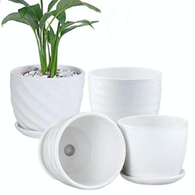 Sietpoek cylinder ceramic planter with attached saucer protects surfaces from water drips.