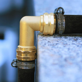 Close-up of brass fittings showing corrosion resistance and 3/4 FHT x 3/4 MHT.