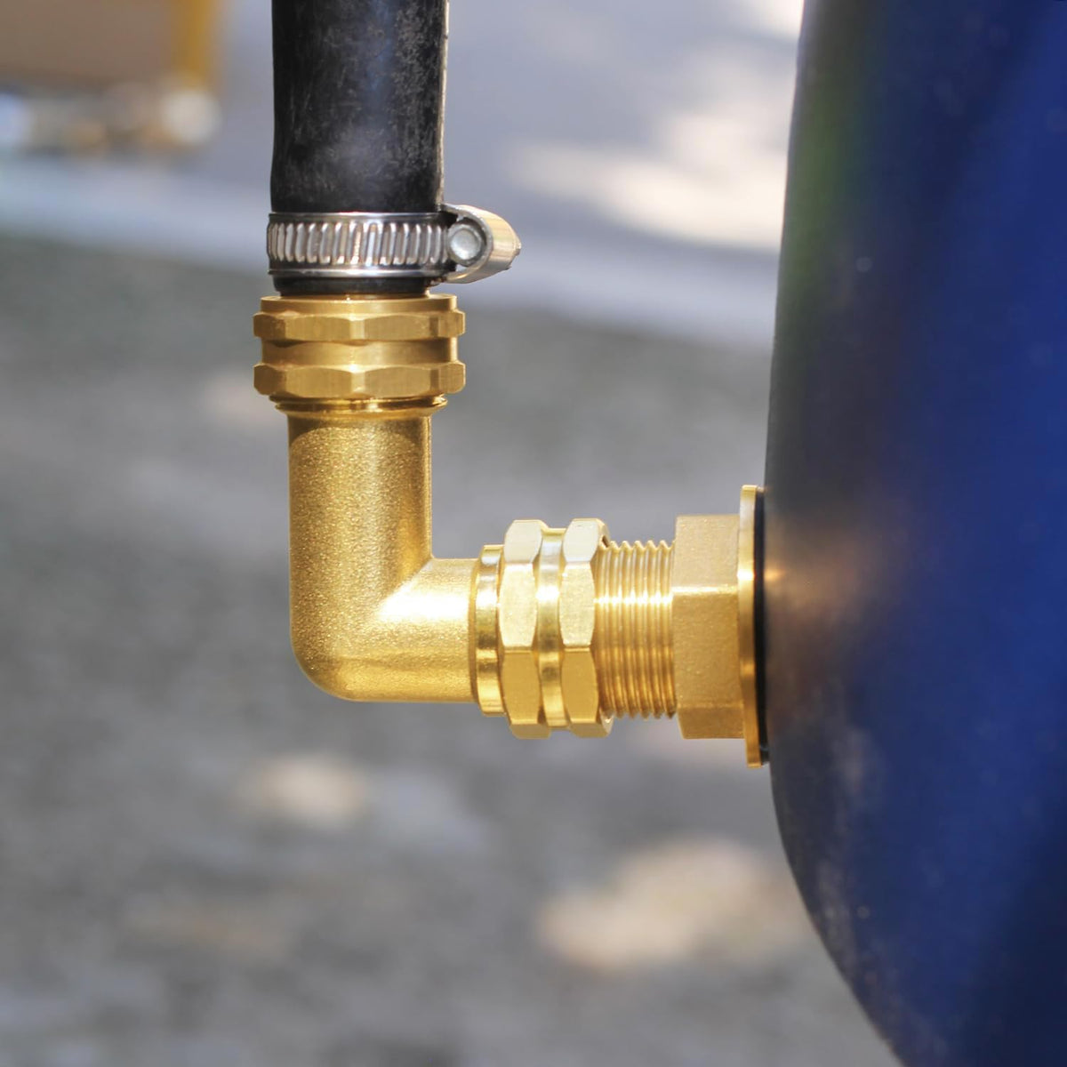 Elbow connected to hose in garden setting illustrates precise 90-degree bend.