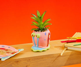 Silver Buffalo Gary planter on shelf brings whimsy to any room.