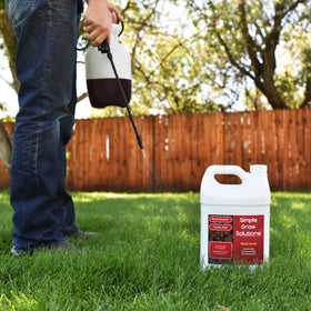 Root Hume bottle against lush turf showing fertilizer synergy.