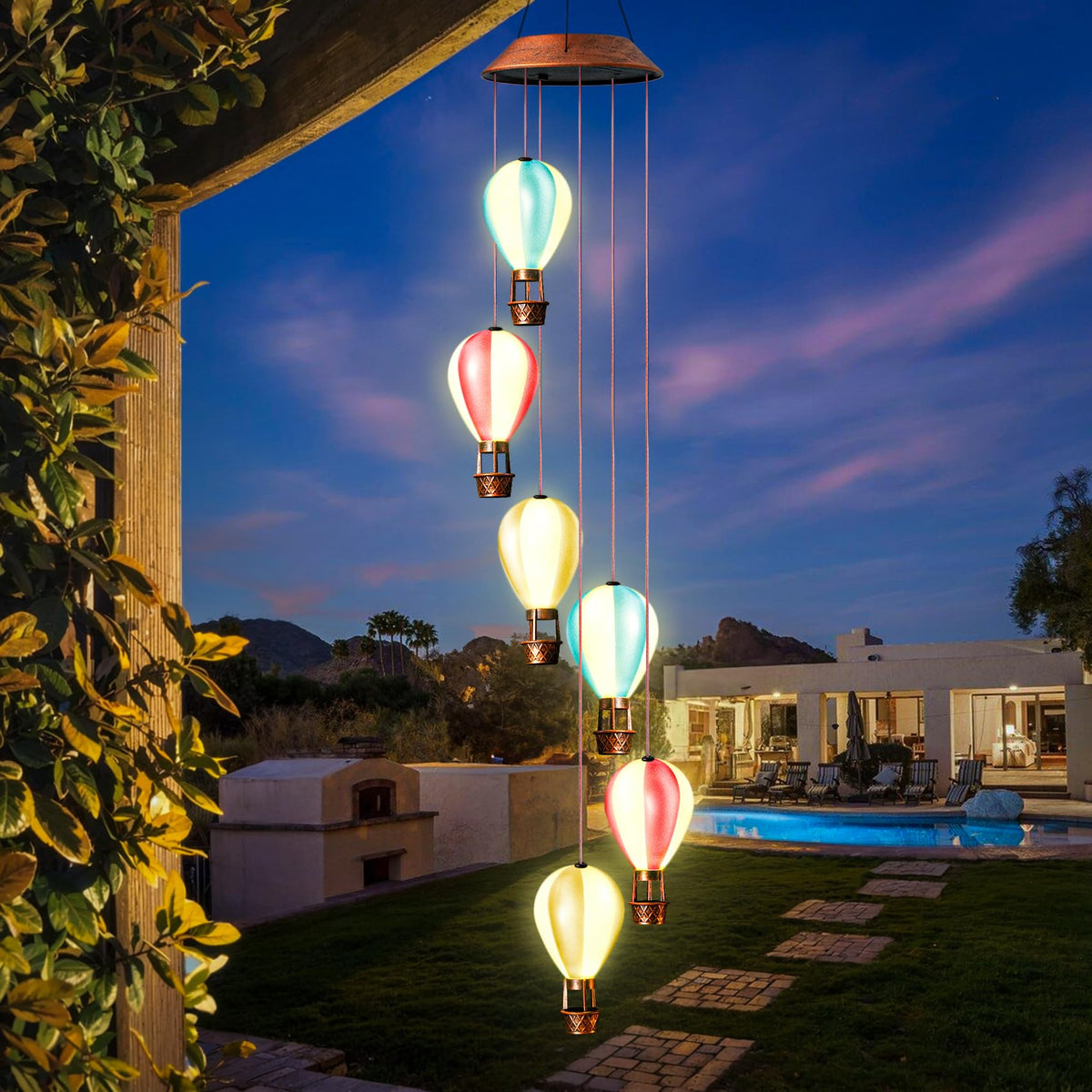 Singingarden solar wind chimes outdoor on fence create a gentle evening glow.