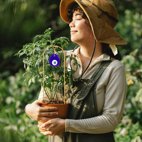 Slepceub decorative garden stake doubles as yard art while supporting ivy and morning glory