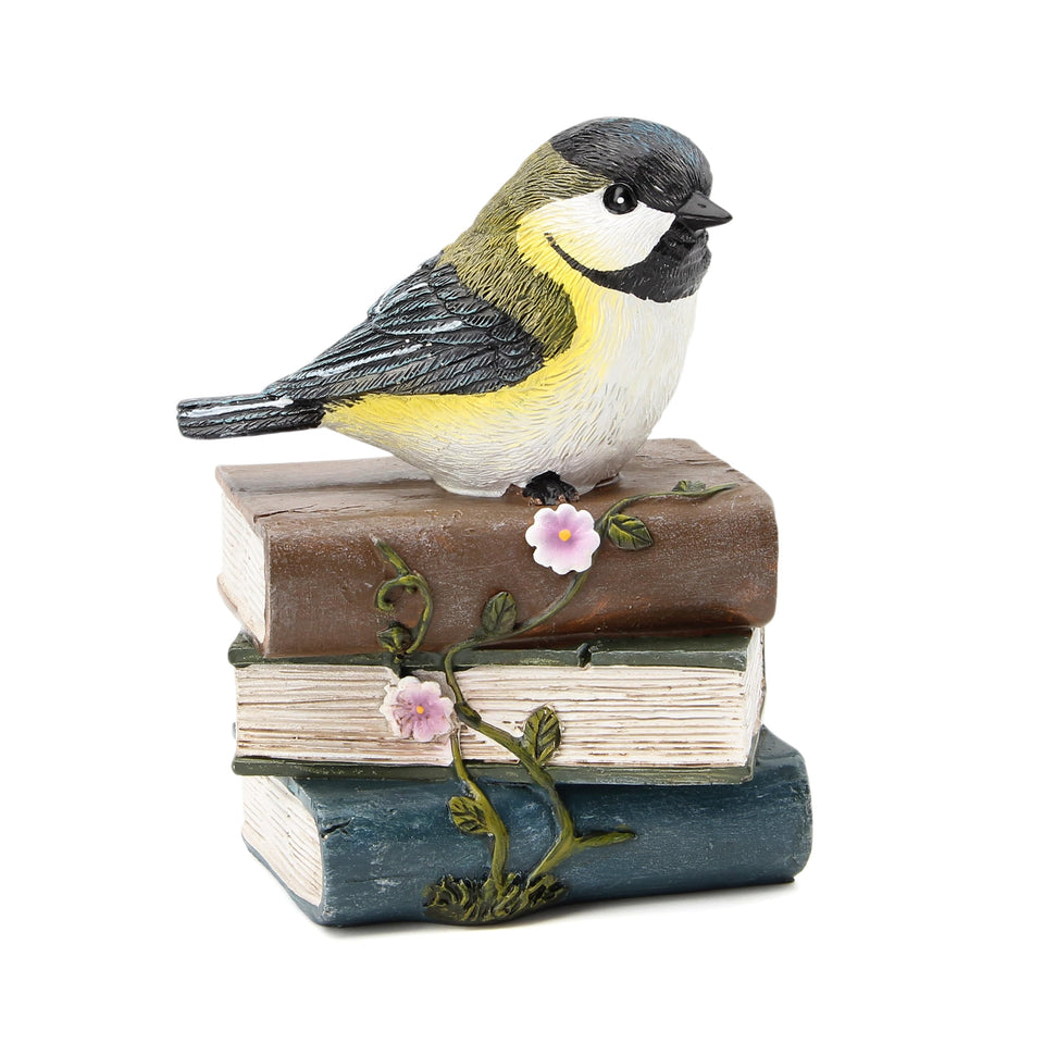Smadeer bird statue on books and vines adds whimsy to garden decor.