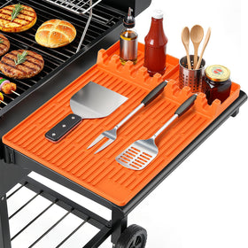 SmartKempt orange grill mat on side shelf keeps tools organized during grilling
