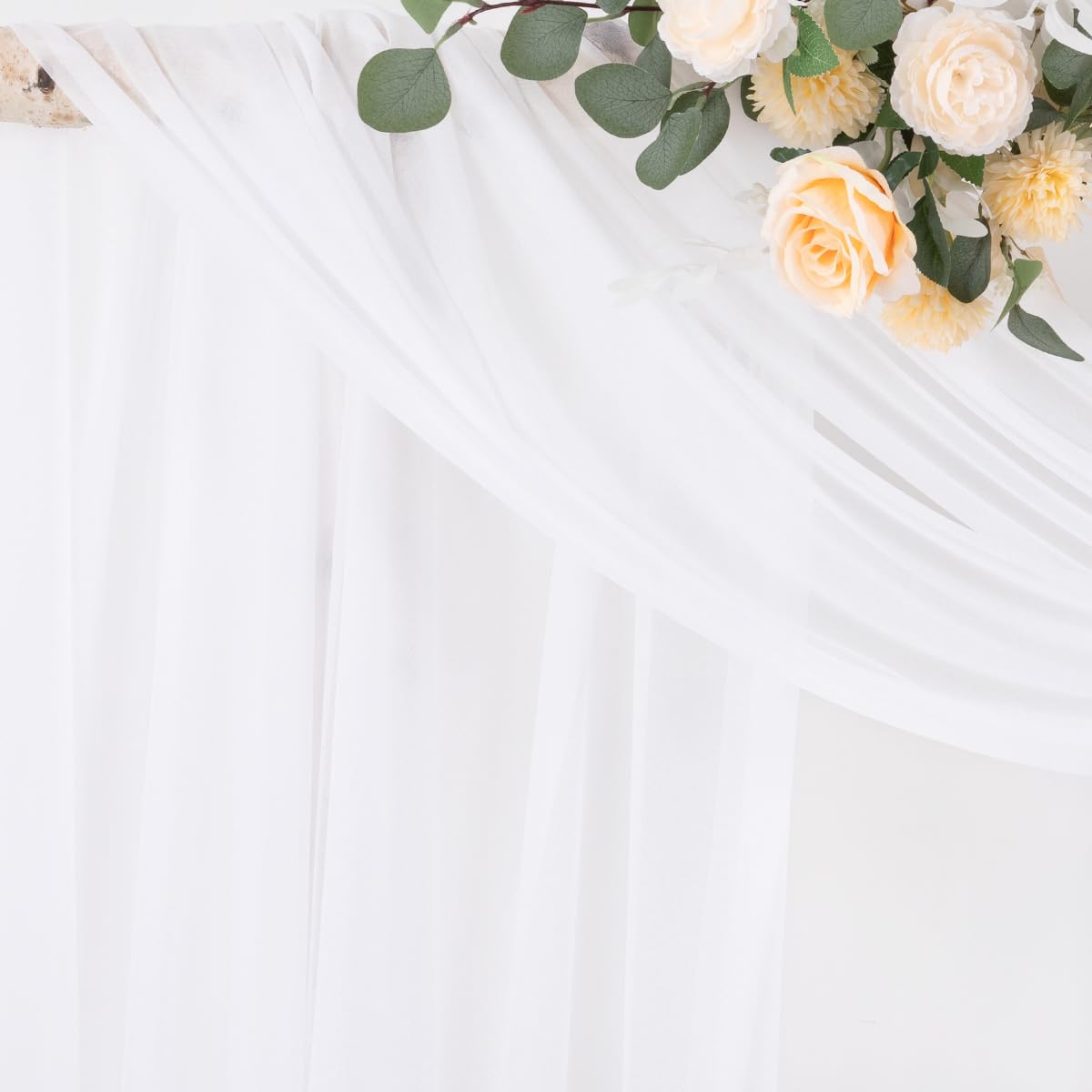Socomi white sheer fabric drape hangs to the floor for photography ready elegance.