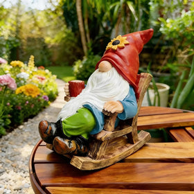 Somdzono outdoor gnome drinks coffee, adding cozy charm to garden paths.