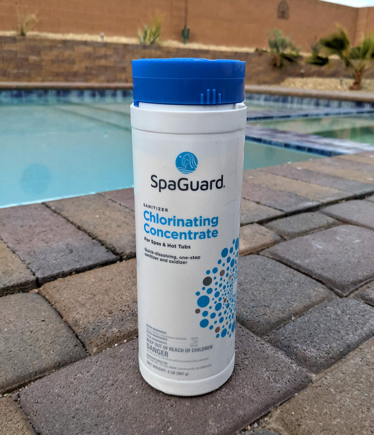 SpaGuard Chlorinating Concentrate being added to running spa water for even dosing and oxidation