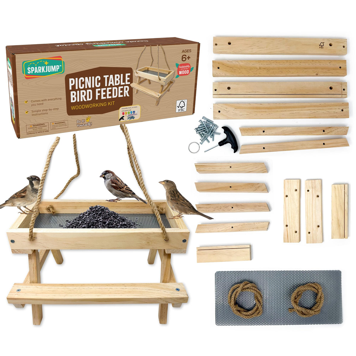 SparkJump Picnic Table Feeder kit contents ready for assembly in a cozy workshop.