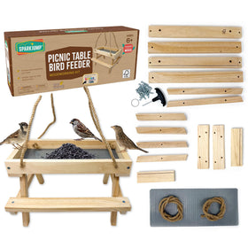 SparkJump Picnic Table Feeder kit contents ready for assembly in a cozy workshop.