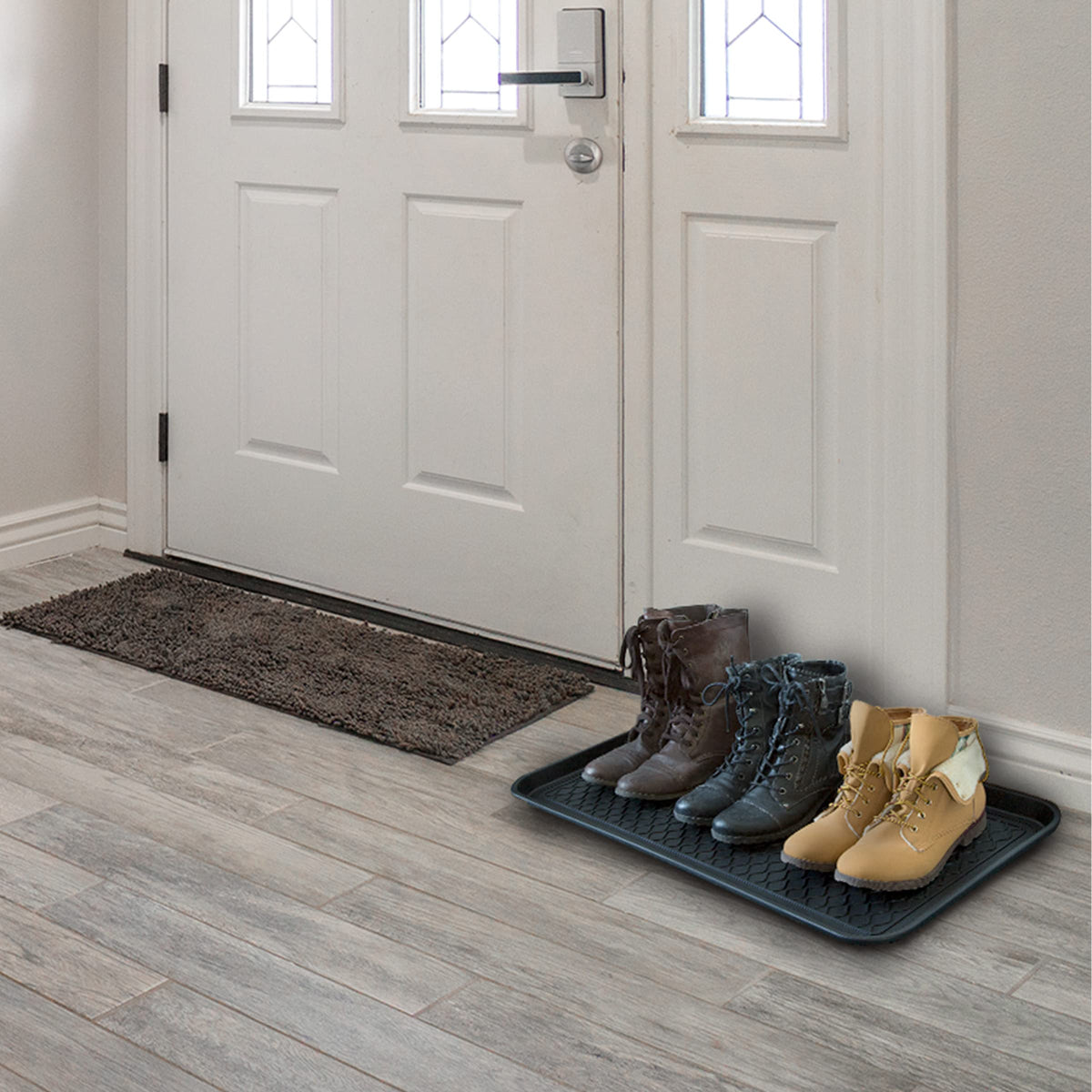 Stalwart boot trays for indoor and outdoor use protect floors from rain and dirt.