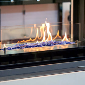 Stanbroil fire glass drops displayed in a lit fire pit with blue tones