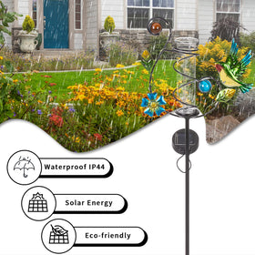 Stargarden hummingbird rain gauge illuminates yard at night