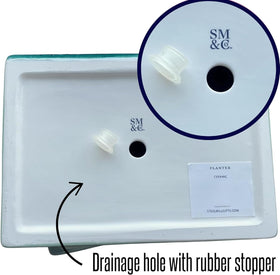 Steel Mill & Co drainage-hole planter includes plug for versatile plant care.