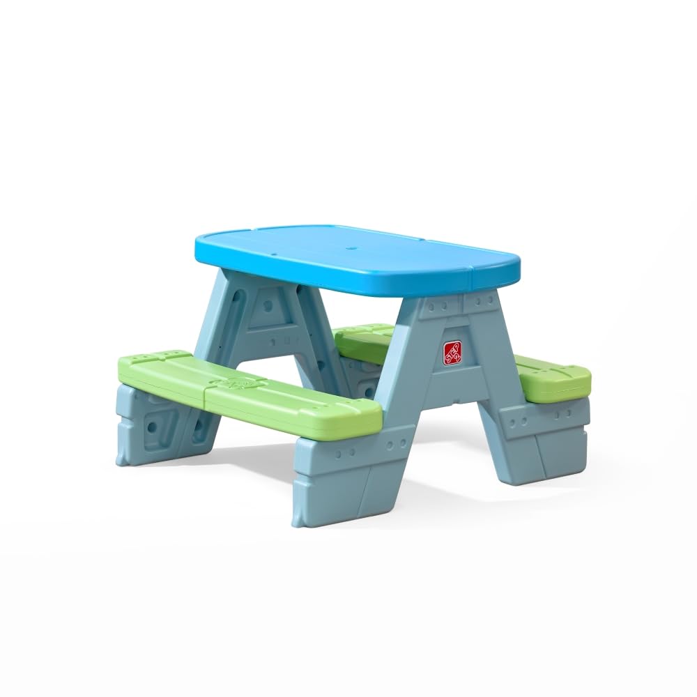 Step2 Sun & Shade picnic table with umbrella provides sun protection for four children outdoors.
