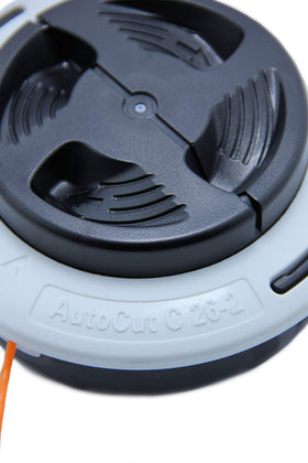 Stihl AutoCut C 26-2 trimmer head spool during use for continuous cutting.