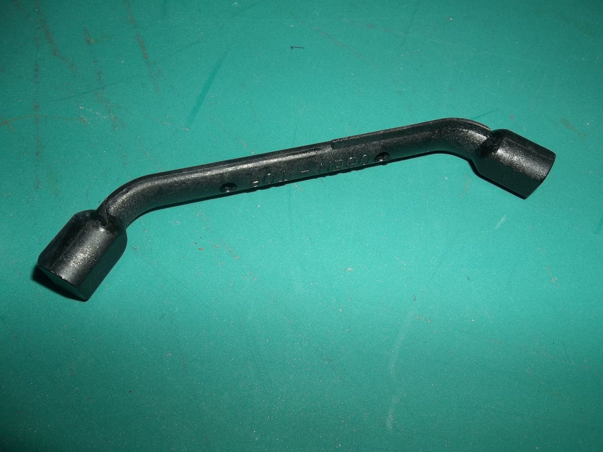 Stihl piston stop tool placed in spark plug port to lock the engine during maintenance