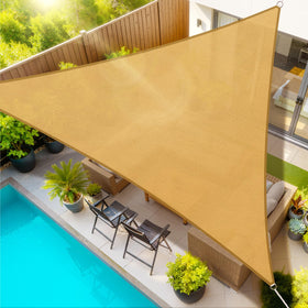 StorageTastic triangle sun shade sail in sand color providing cool, UV-blocking shade for patios.