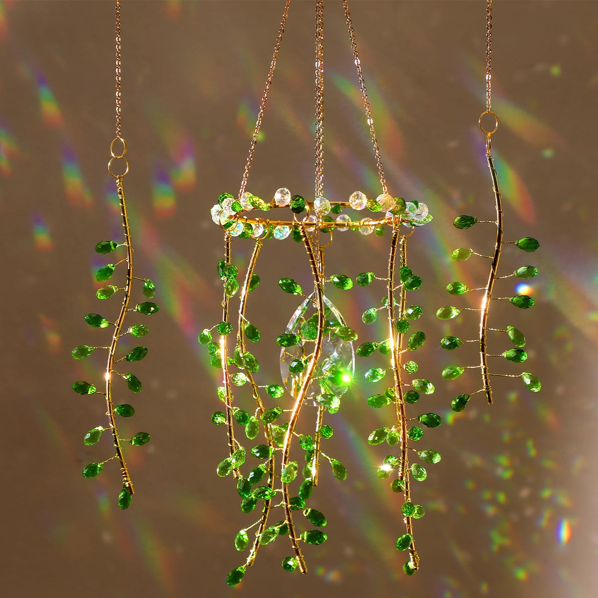 Suncalla crystal suncatchers by window with green leaf crystal, adding colorful light.