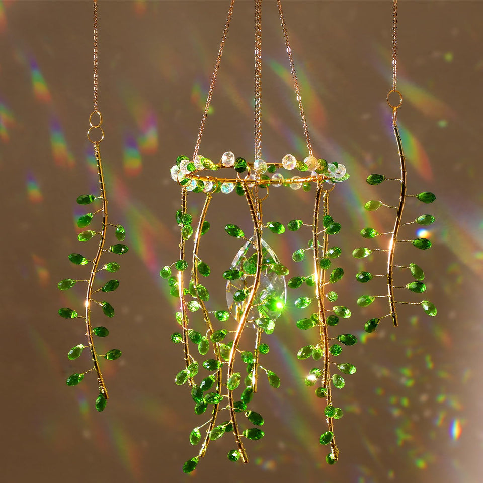 Suncalla crystal suncatchers by window with green leaf crystal, adding colorful light.