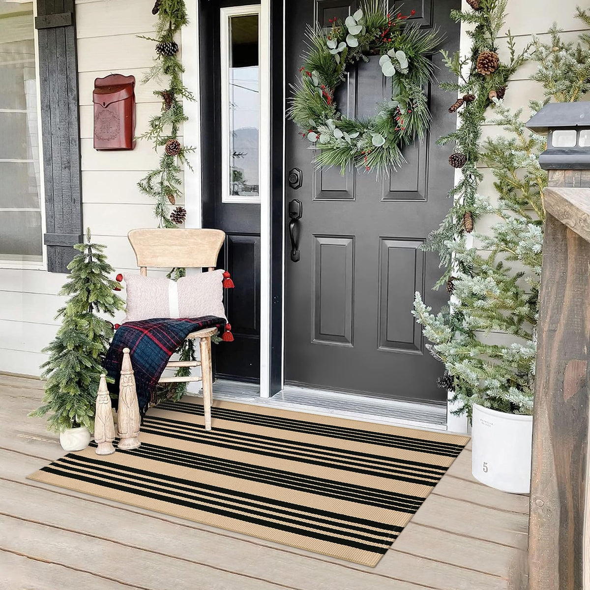 Sungea rug with black and khaki stripes on a front door for welcoming curb appeal.