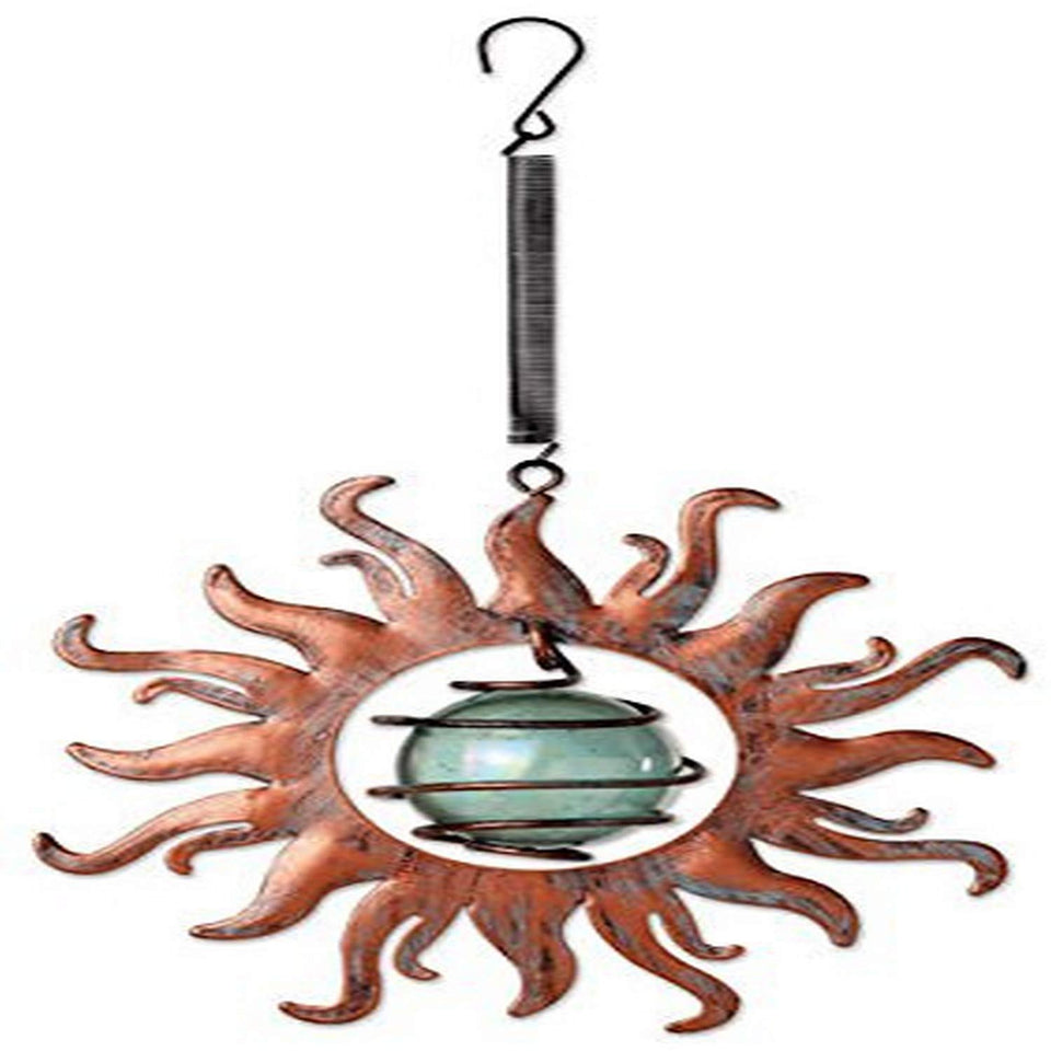 Sunset Vista Designs vintage copper sun bouncy hanging decoration catching sunlight on a garden gate