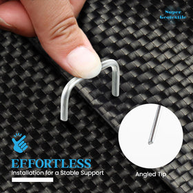Ground fabric installation with stakes driven into soil for stability.