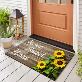 SuQKXCo Sunflower Welcome Doormat front porch with wood background, inviting entry.