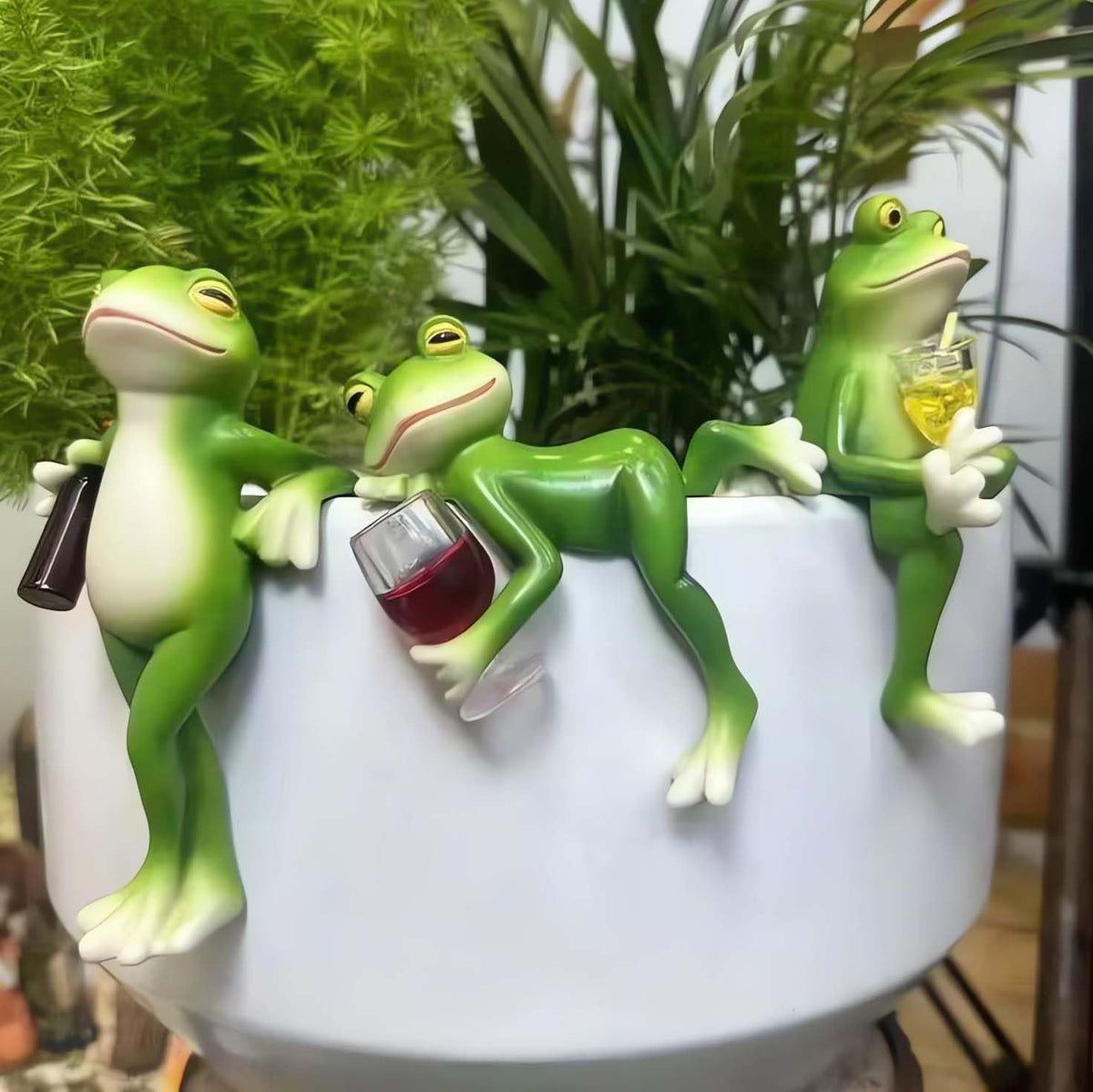 Suqorinp tipsy frog pot hugger trio on plant pot for whimsy