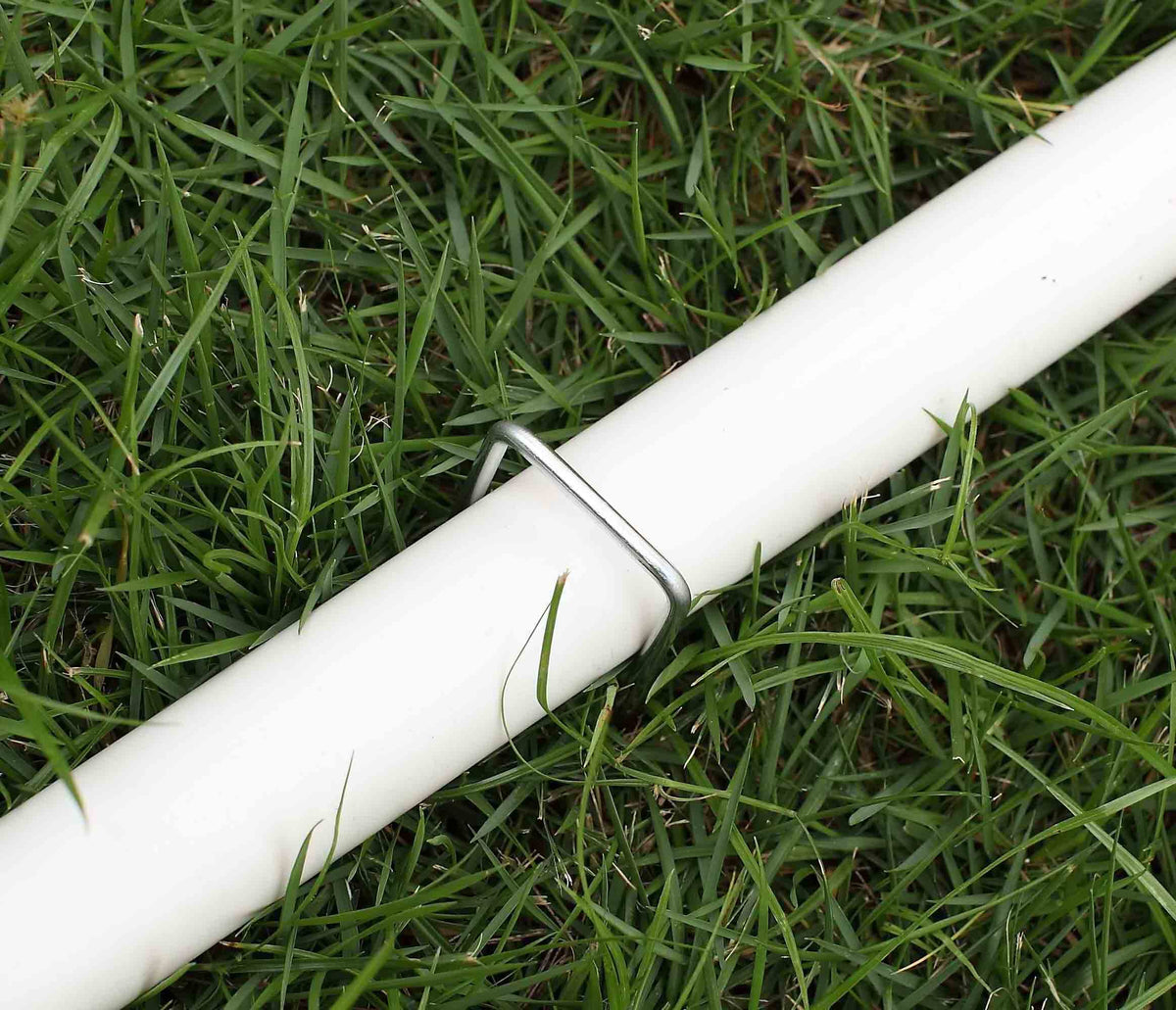 Sweecomb stakes securing bird netting, chicken wire, and edging outdoors.