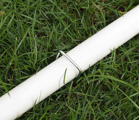 Sweecomb stakes securing bird netting, chicken wire, and edging outdoors.