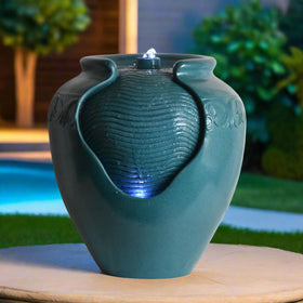 Teamson Home teal pot fountain as garden decor centerpiece at outdoor space.