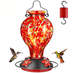 Tegarbed hummingbird feeder with red polka dots seen from the side, ready to attract pollinators.