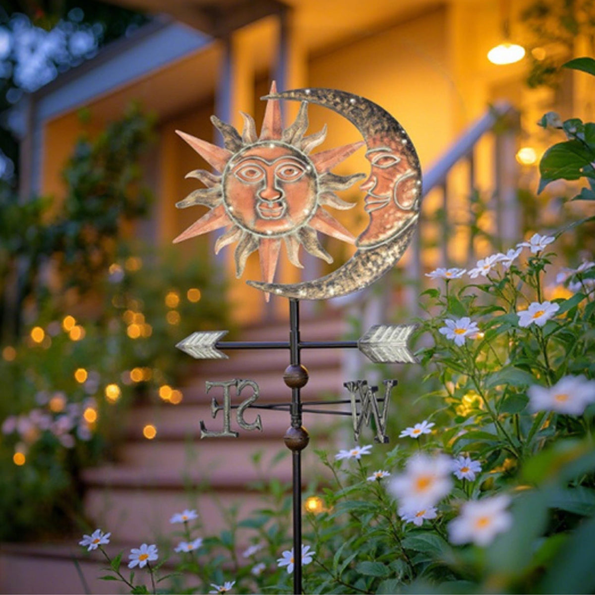 Solar-lit night view of the sun-moon weathervane brightens pathways after dusk.