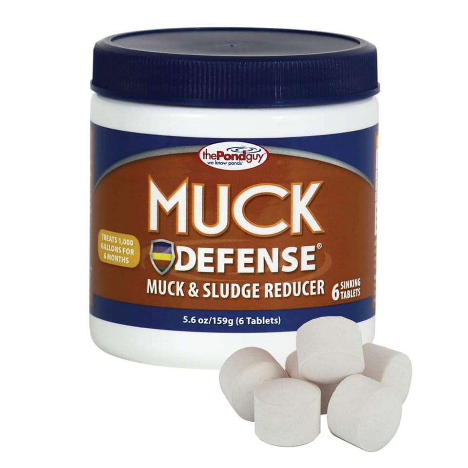 The Pond Guy Muck Defense tablets dissolving in pond water to digest debris